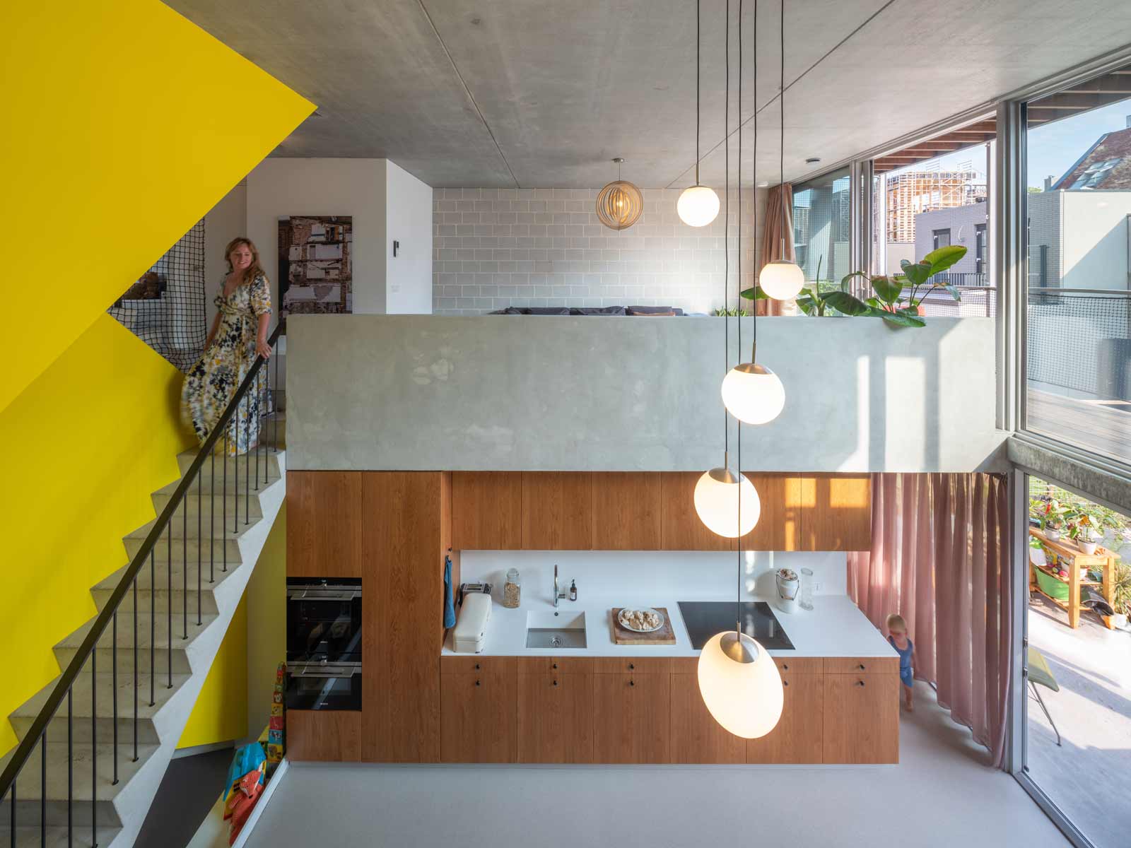three generation house by BETA photo interior kitchen and living room void with yellow staircase by Ossip Evert Klinkenberg Auguste Gus van Oppen