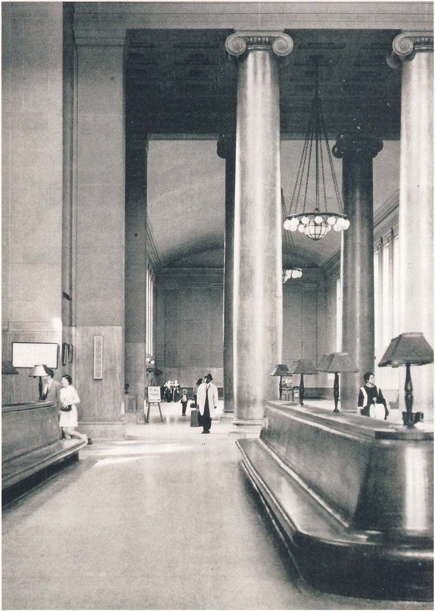 historic photo of a high station interior with wooden benches in the foreground