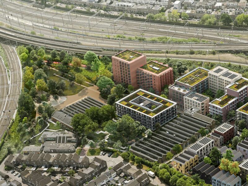 Aerial render of Wisselspoor District with buig buildings and lots of green space in between the railroad tracks in Utrecht.