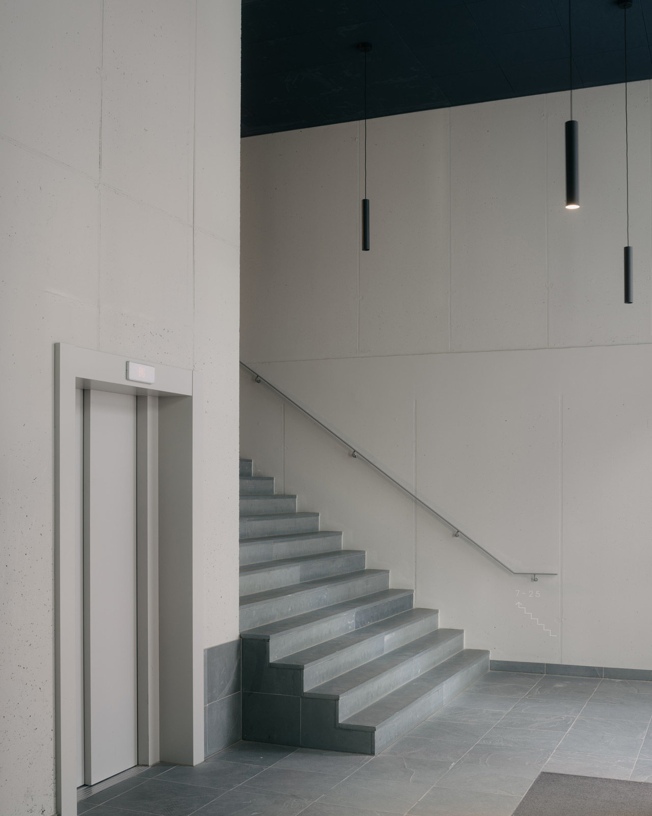 interior entrance photo with staircase and elevator in Oostenburg apartment block Draaier by BETA architect amsterdam evert klinkenberg gus auguste van oppen image by Stijn Bollaert